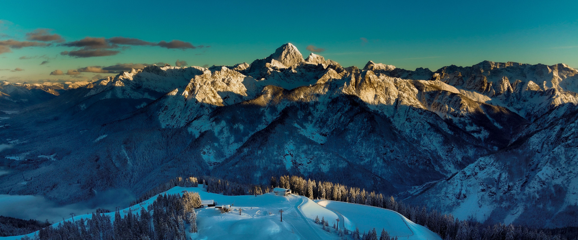 Sonnenaufgangsstimmung mit Blick vom Skigebiet Tarvisio Richtung Mangart im Osten